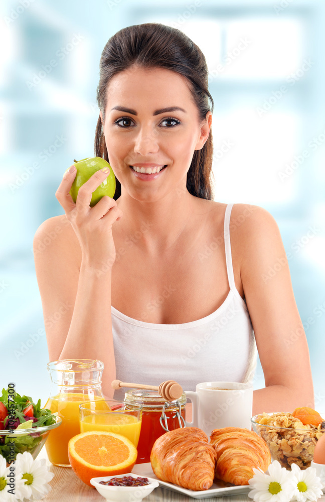 Young woman having breakfast. Balanced diet Young woman having breakfast. Balanced diet