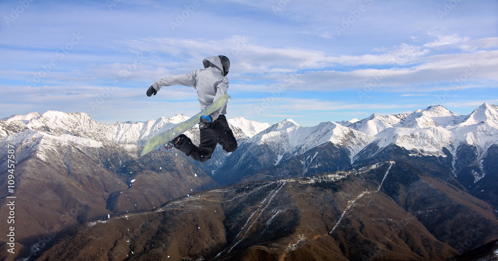 Obraz premium Snowboard rider jumping on mountains. Extreme snowboard freeride sport.