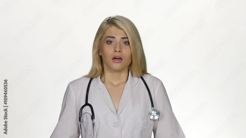 Shocked young female doctor. White. Slow motion Shocked young female doctor. White. Slow motion