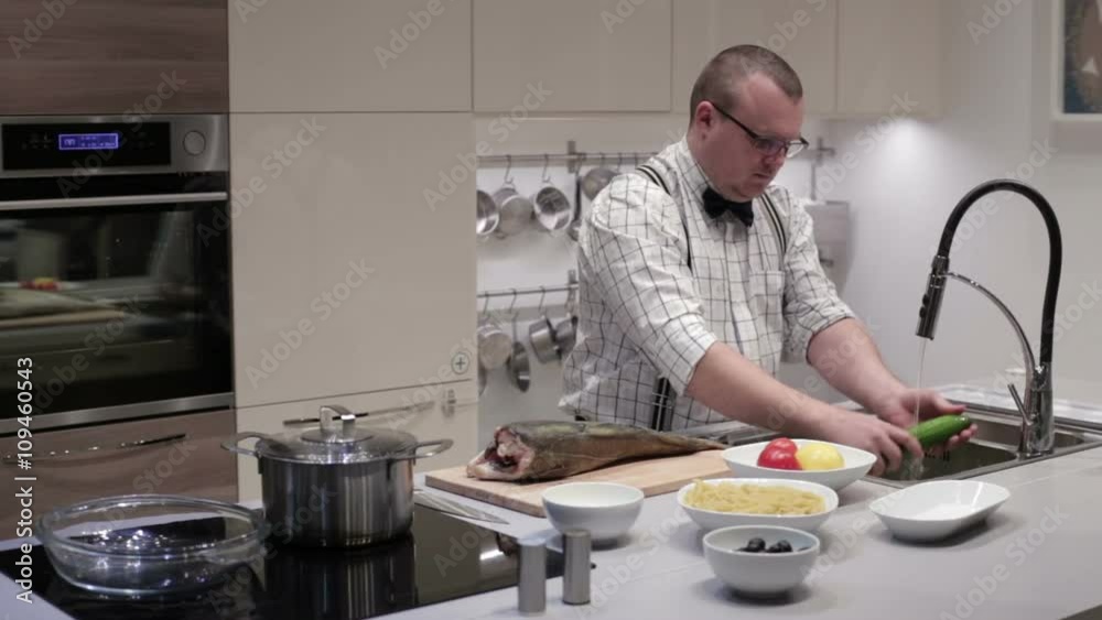 The man in the kitchen washes vegetables The man in the kitchen washes vegetables