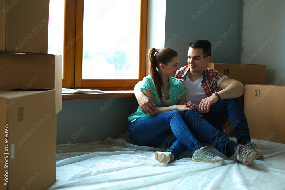 Portrait of young couple moving in new home Portrait of young couple moving in new home