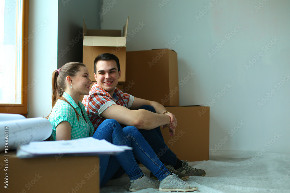 Portrait of young couple moving in new home Portrait of young couple moving in new home