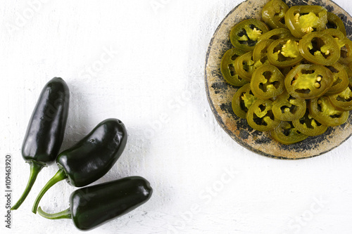 Green fresh and delicious sliced pickled jalapenos photo