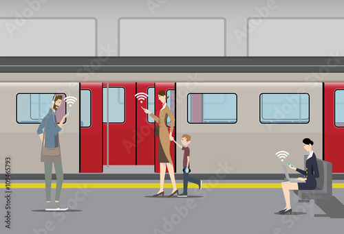 Public Free Wifi Concept. Passengers use their mobile devices on the subway platform.