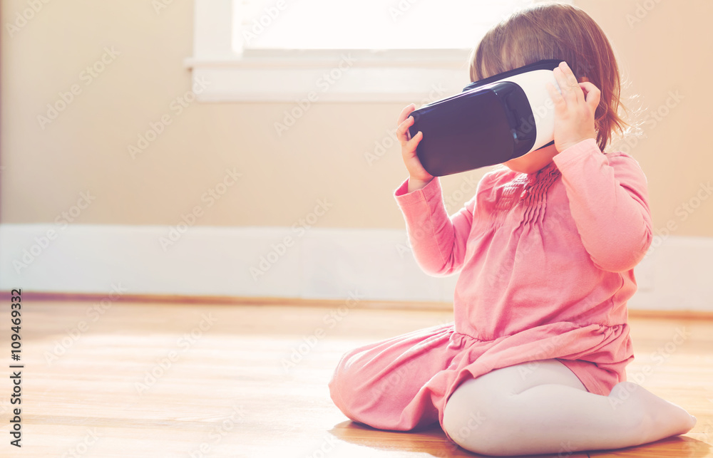 Toddler girl using a virtual reality headset Toddler girl using a virtual reality headset