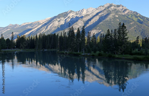 Mount Norquay reflecting in the Bow river. Shot in the Banff town site, in Banff National Park, Alberta, Canada..