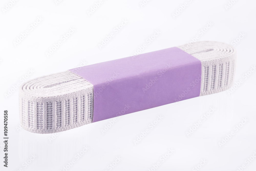 Large elastic band wrapped in paper isolated on white background Large elastic band wrapped in paper isolated on white background
