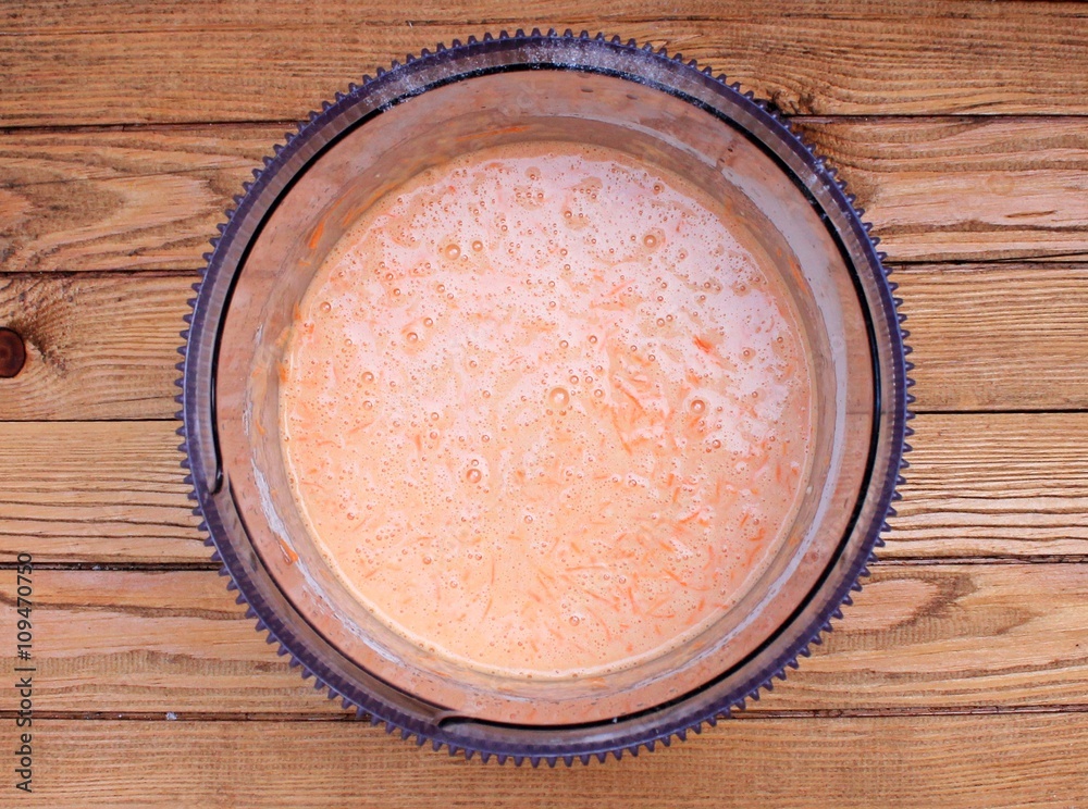 Dough for carrot cake on a wooden table Dough for carrot cake on a wooden table