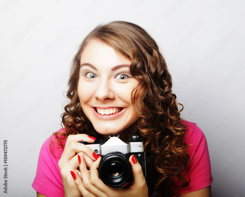 Fototapeta premium young pretty woman holding vintage camera