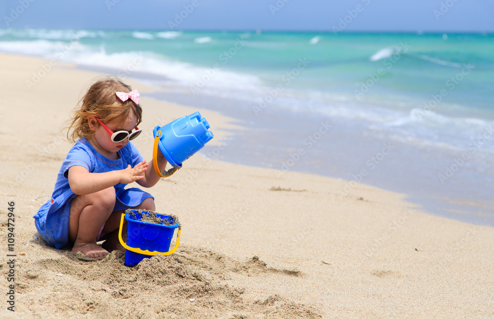 little girl play with sand on beach little girl play with sand on beach