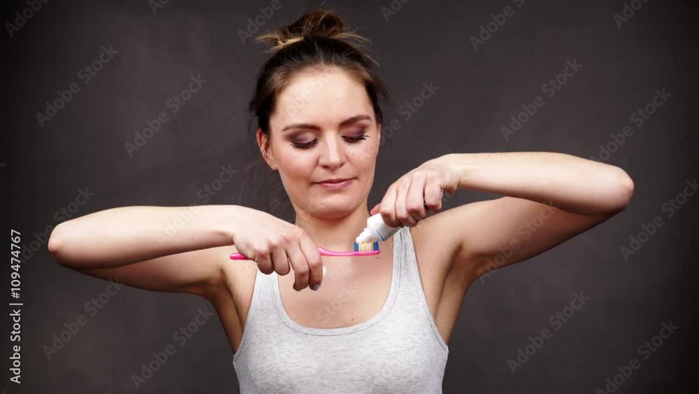 Woman holding toothbrush and placing toothpaste on it 4K Stock Video ...
