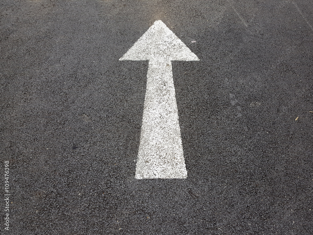 White arrow symbol on the road White arrow symbol on the road