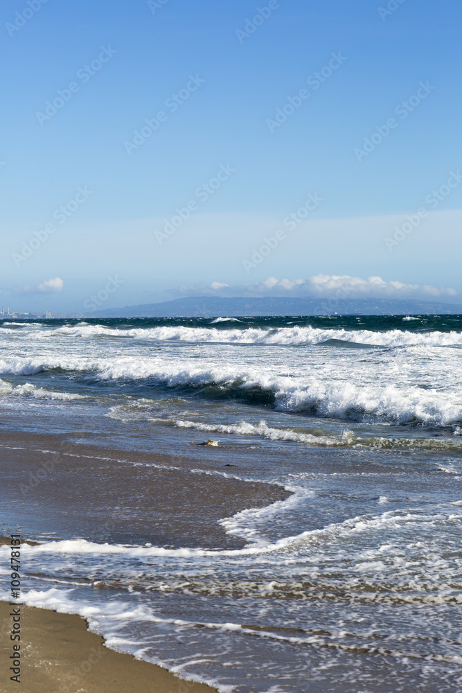 Pacific ocean is clear day. Beach landscape in the USA with the blue sea, Santa Monica. 