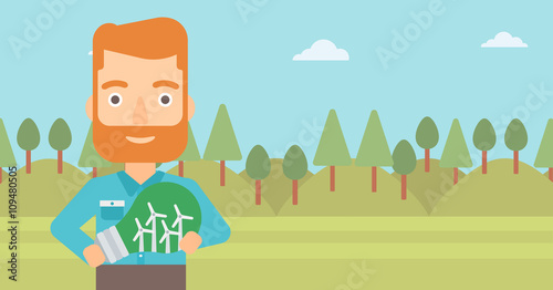 Man holding lightbulb with windmills inside.