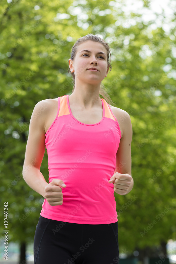 Young sporty woman running in park Young sporty woman running in park