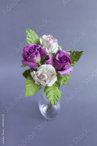 Paper roes flower on grey background © sirirak