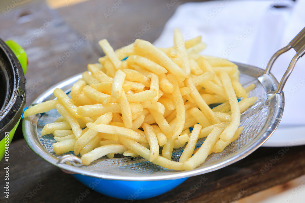 French fries cooking on deep fryer. French fries cooking on deep fryer.