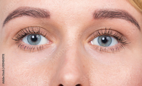 Closeup of blue eyes woman without makeup