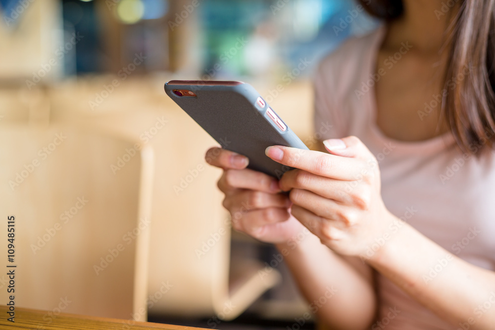 Woman sending sms on cellphone