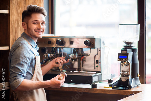 Pleasant barista working in the cafe photo