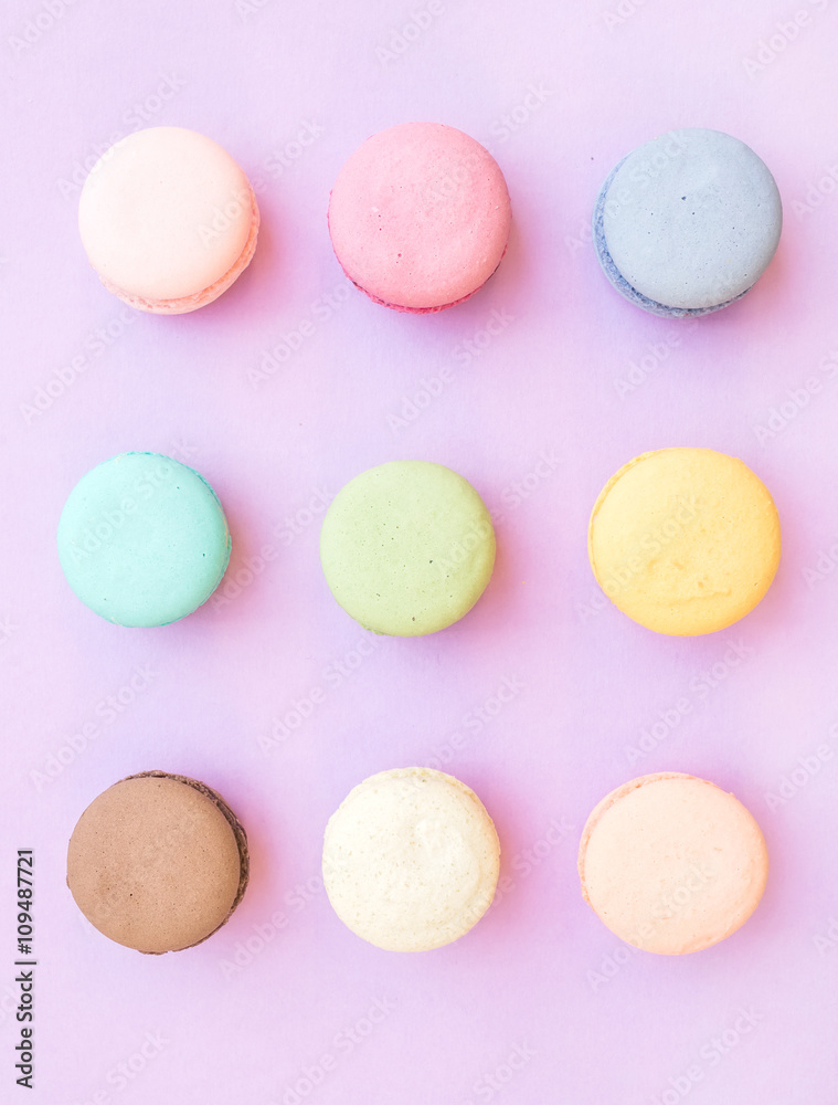Sweet colorful French macaroon biscuits on pastel lilac background Sweet colorful French macaroon biscuits on pastel lilac background