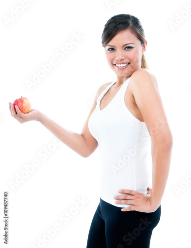 Happy Young Fitness Woman Presenting An Apple