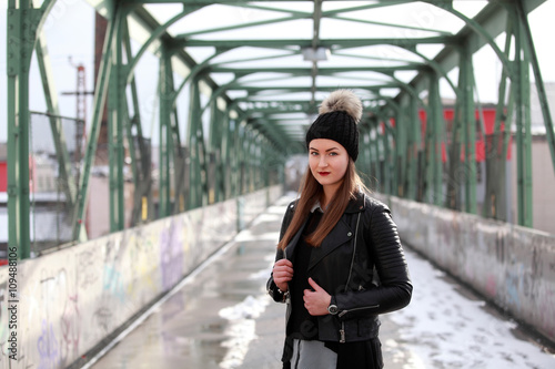 Beautiful girl with bobble hat and black leather jacket