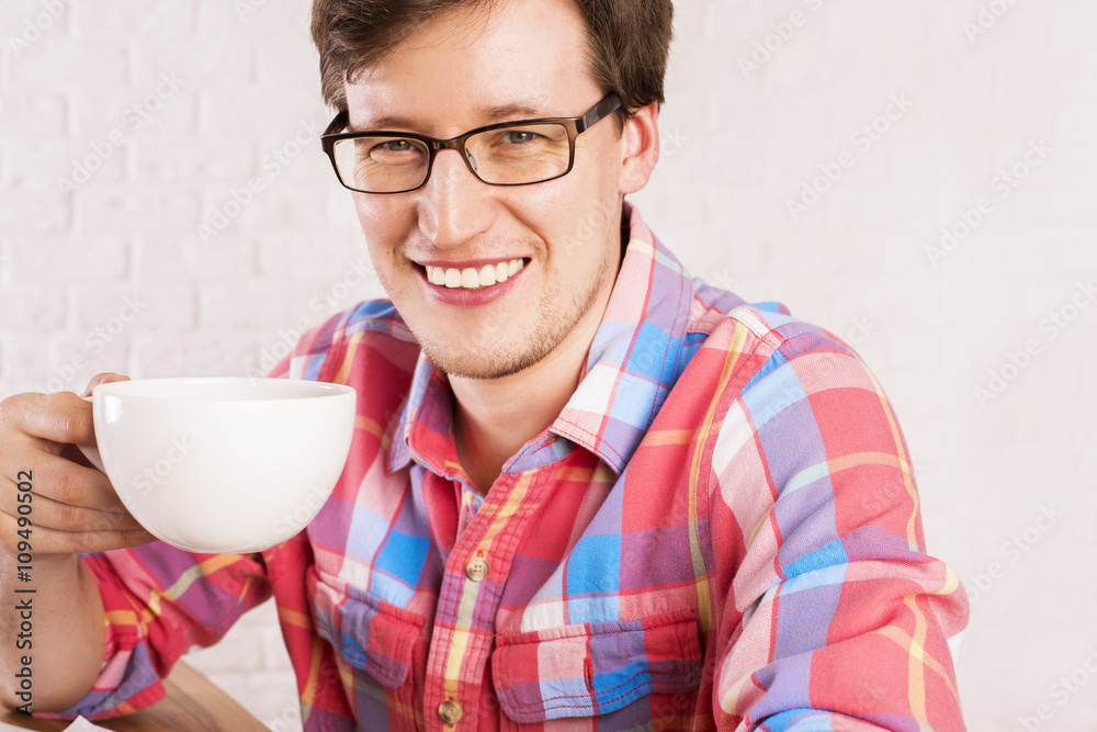 Smiling man with coffee cup