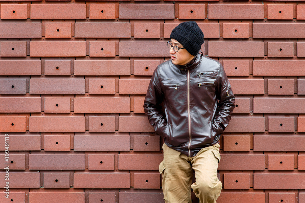 An Asian Man in a Brown Jacket 