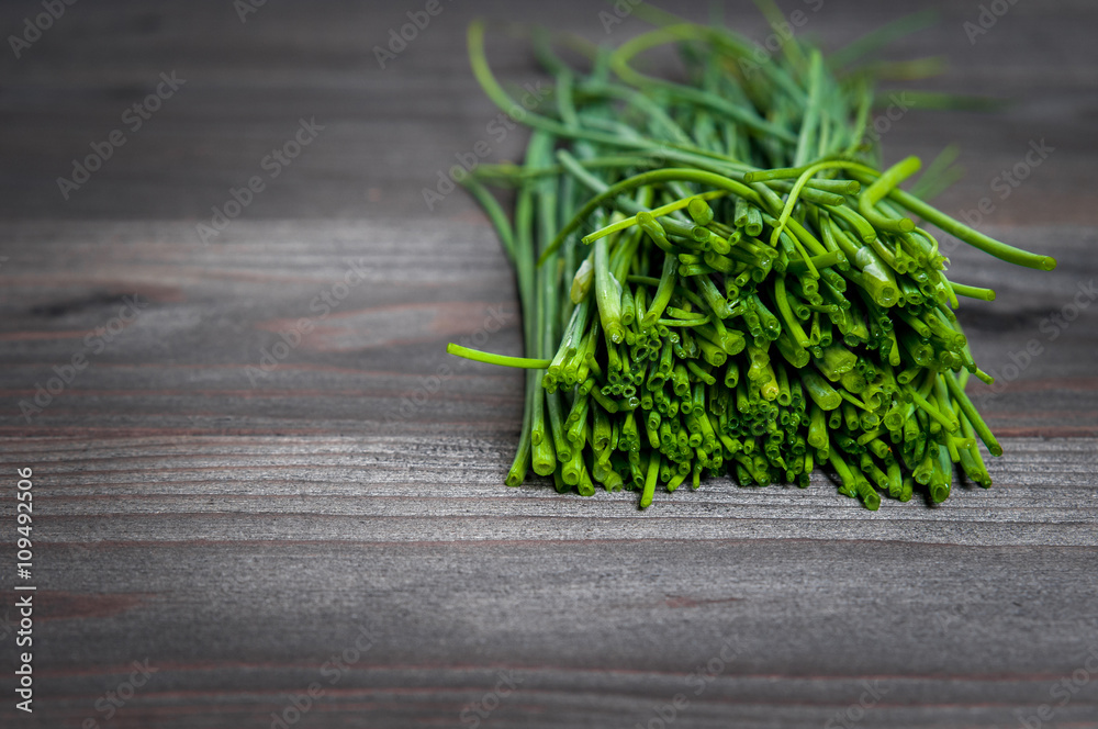 bunch of fresh chives on a wooden cutting board, selective focus bunch of fresh chives on a wooden cutting board, selective focus