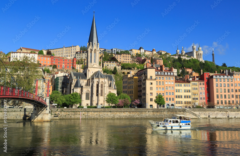 Boat in the Saone rivier in front of the Church of Saint Georges, Lyon, France.
