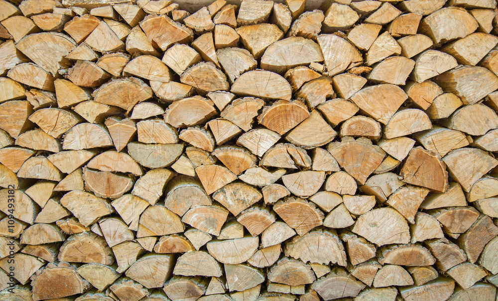 the chopped firewoods are neatly put, supply of firewoods on a w the chopped firewoods are neatly put, supply of firewoods on a w
