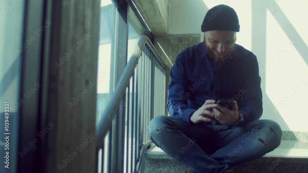 man sitting on stairs using smartphone
man sitting on stairs using smartphone