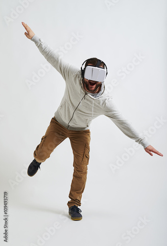Fototapeta Naklejka Na Ścianę i Meble -  Man balancing on one leg in 3d glasses