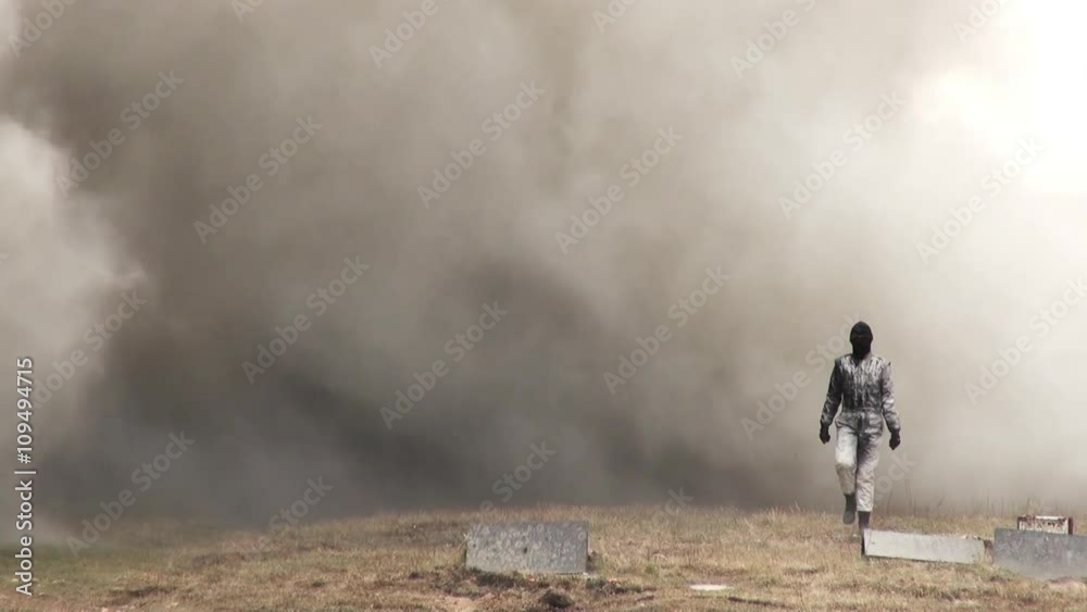 Stunt girl in a fiery explosion. Slow motion. Beautiful girl stunt runs across the field through the explosions and fire. Stunt girl in a fiery explosion. Slow motion. Beautiful girl stunt runs across the field through the explosions and fire.