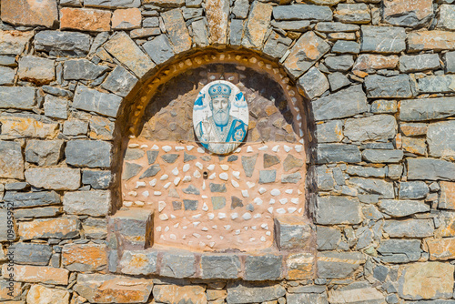 Beautiful stone wall of the orthodox church of Saint Nicholas the Wonderworker, built under the rock. District of Rethymno. Crete island. Greece. Europe. photo