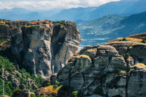 View of The Holy Monastery of St. Stephen at the complex of Meteora monasteries in Greece. Steep cliffs and mountains in the valley of Thessaly