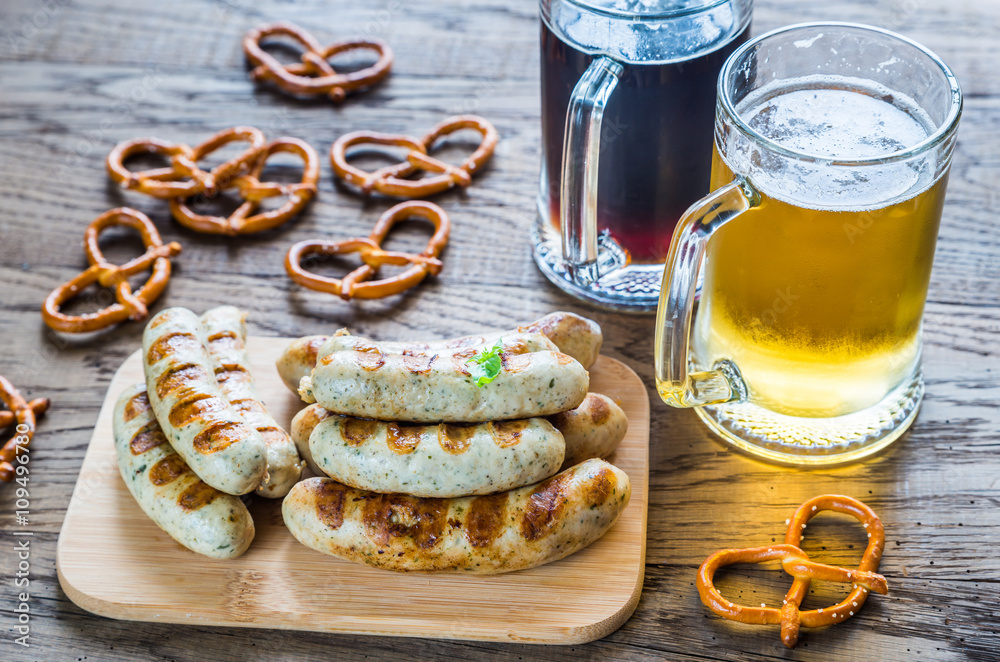 Grilled sausages with pretzels and mugs of beer