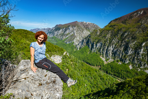 Happy lady on top of mountain