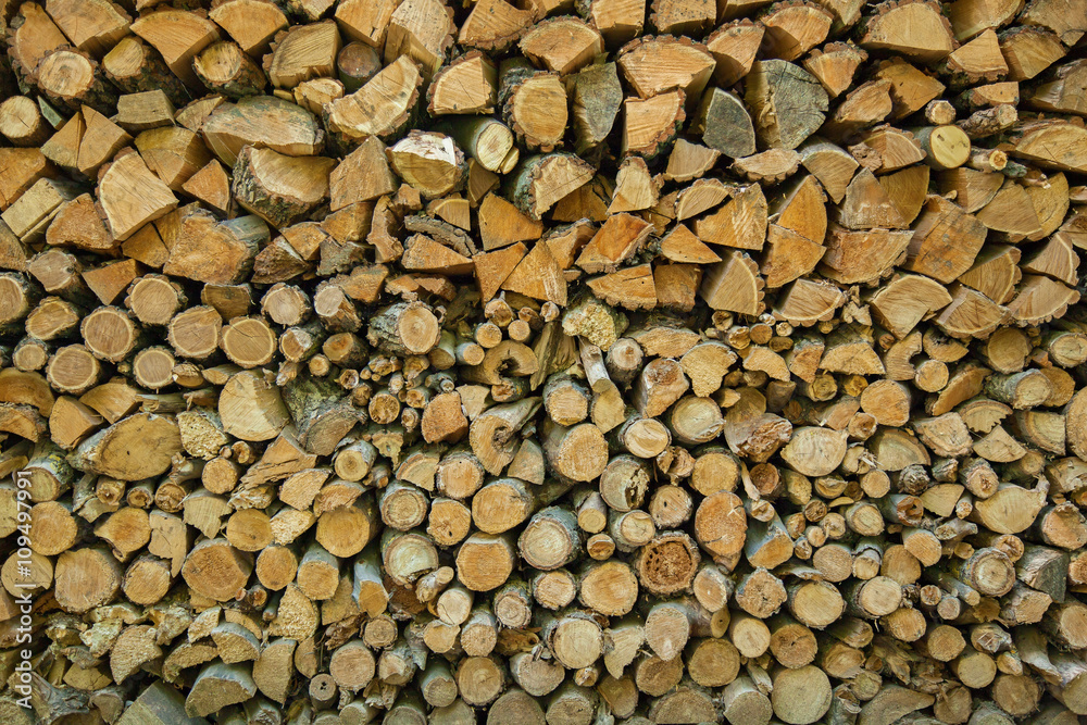 the chopped firewoods are neatly put, supply of firewoods on a w the chopped firewoods are neatly put, supply of firewoods on a w