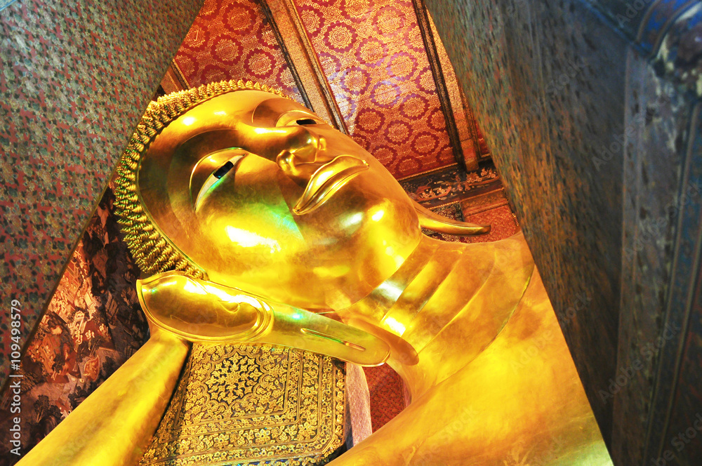 Reclining Buddha gold statue face from bottom view. Wat Pho, Bangkok, Thailand