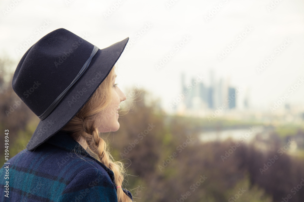 Woman enjoing the view from observation desk, skyscrapers at  background