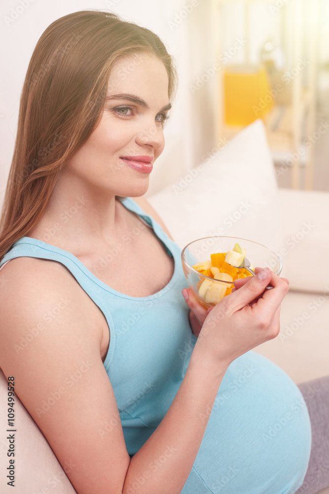 Cheerful pregnant woman is eating healthy salad Cheerful pregnant woman is eating healthy salad