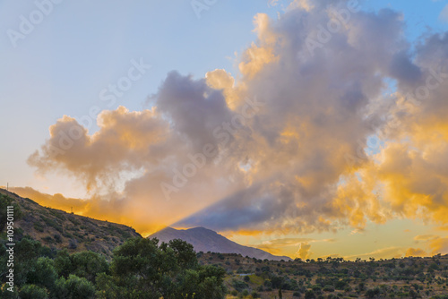 Beautiful sunset in the mountains of Crete island.The last rays of sun light up the mountains and the sky.Mountain landscape.District of Rethymno.Greece. Europe.