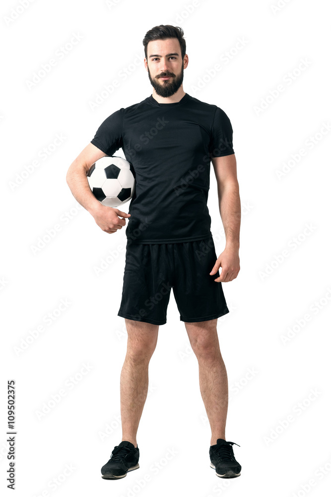 Smiling soccer or futsal player wearing black sportswear holding ball under  his arm looking at camera. Full body length portrait isolated over white  background. Stock-Foto | Adobe Stock