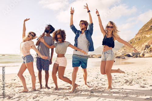 Group of friends having fun at beach