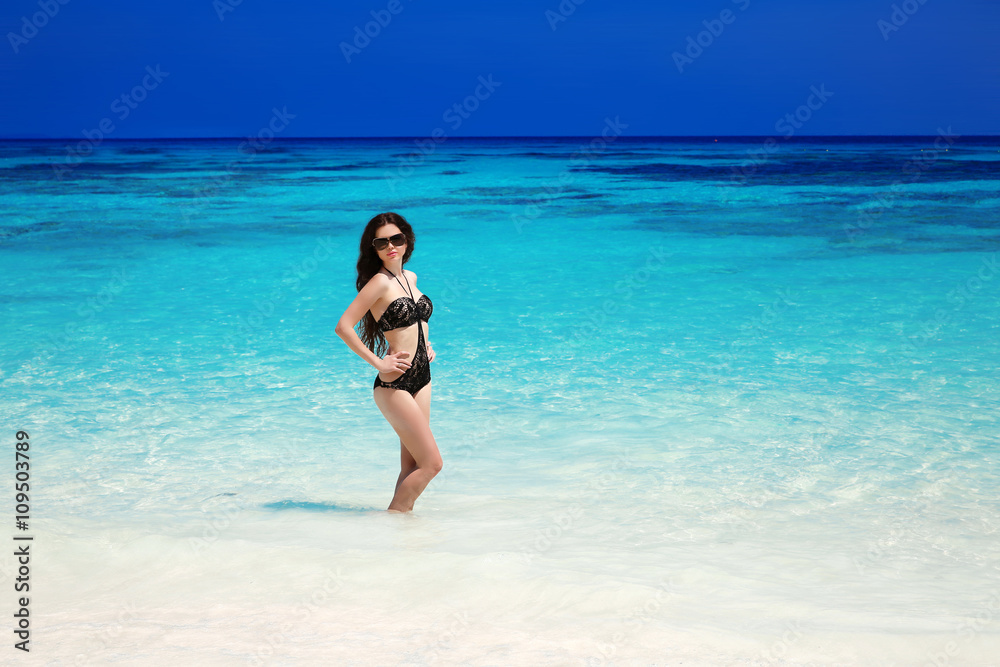 Beautiful sexy bikini model. Tropical beach. Outdoor portrait of