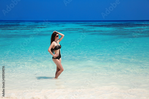 Beautiful sexy bikini girl model sun-tanned On Tropical Beach. O