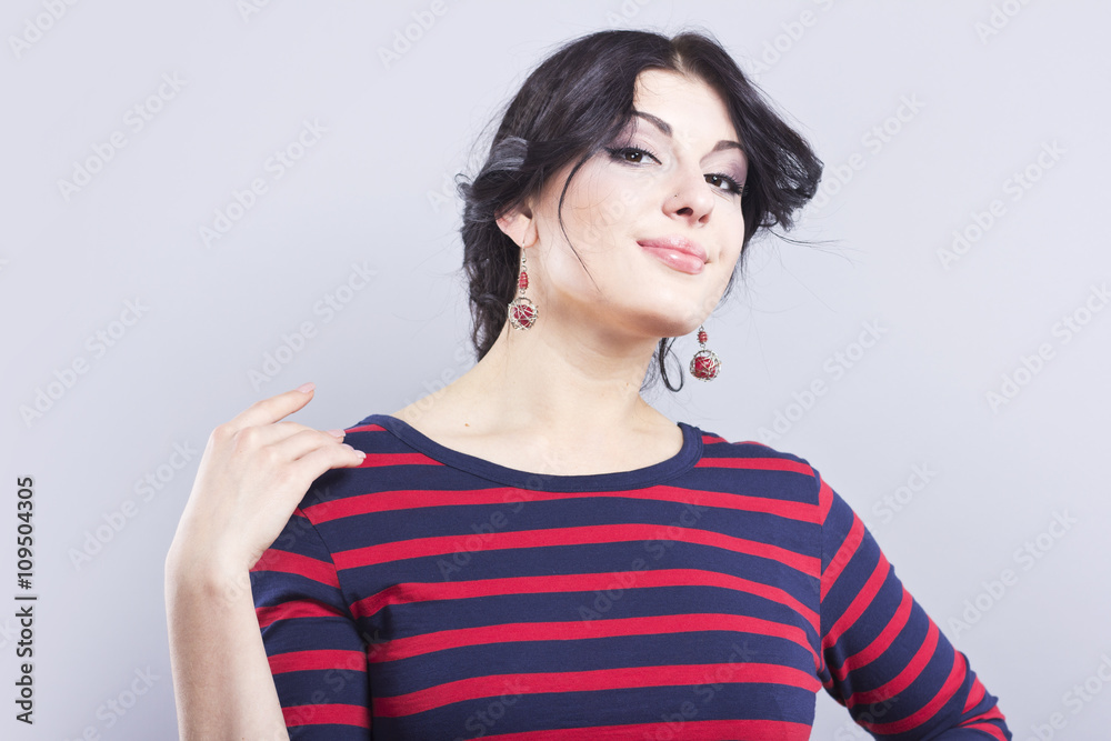 Beautiful girl in a striped dress. Smiling brunette on a black background. Portrait of smart woman
Beautiful girl in a striped dress. Smiling brunette on a black background. Portrait of smart woman