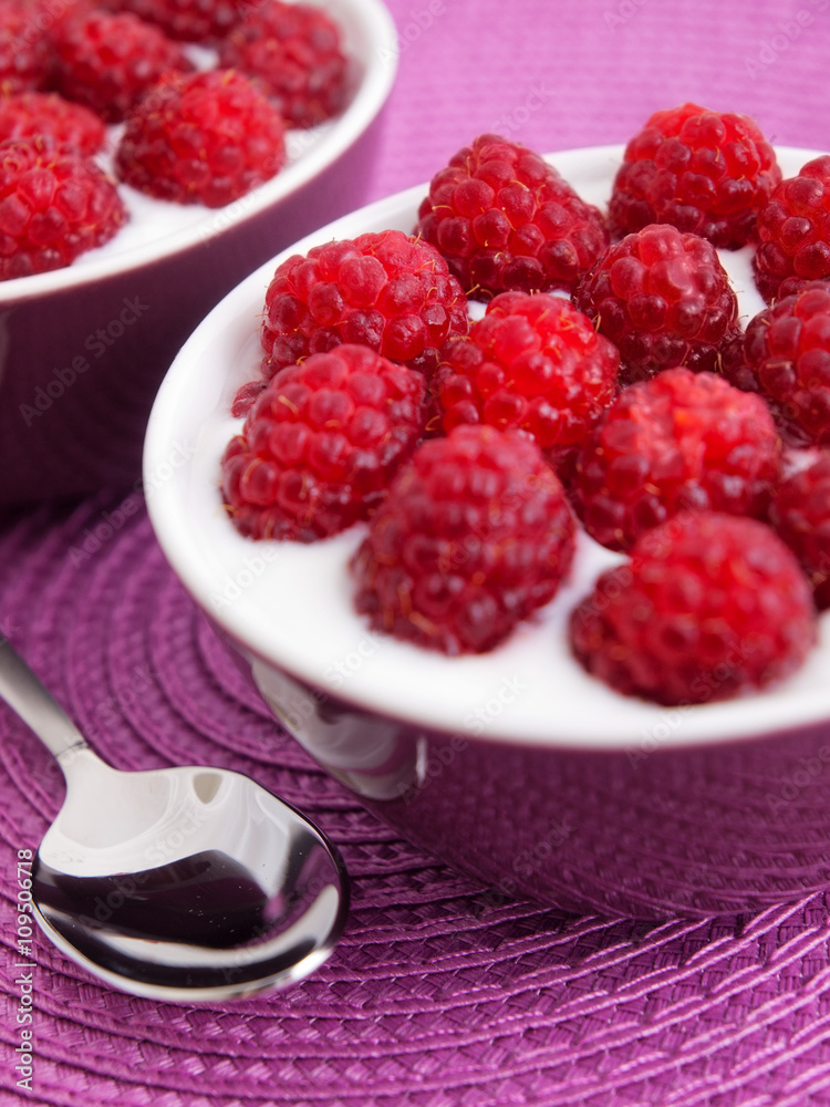 Dessert made from sweet vanilla egg cream with raspberries on top. Vertical shot. Dessert made from sweet vanilla egg cream with raspberries on top. Vertical shot.